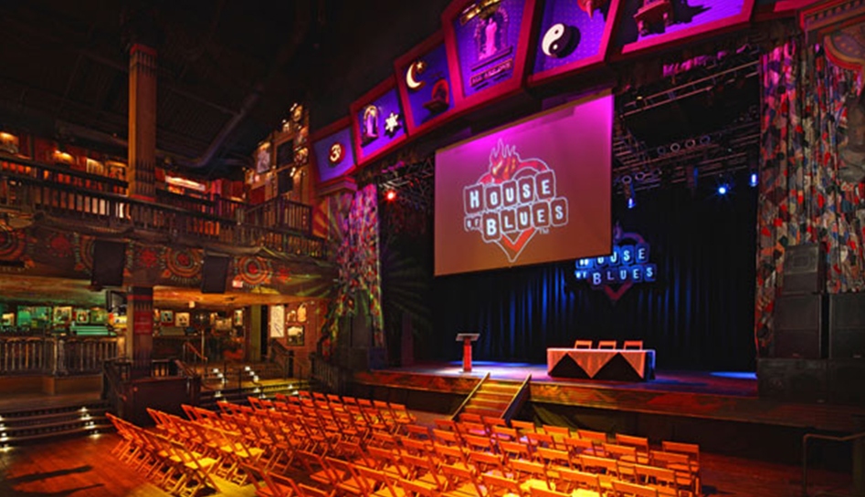 View of the stage inside of House of Blues with chairs lined in front of it for seating. Orlando, Florida.