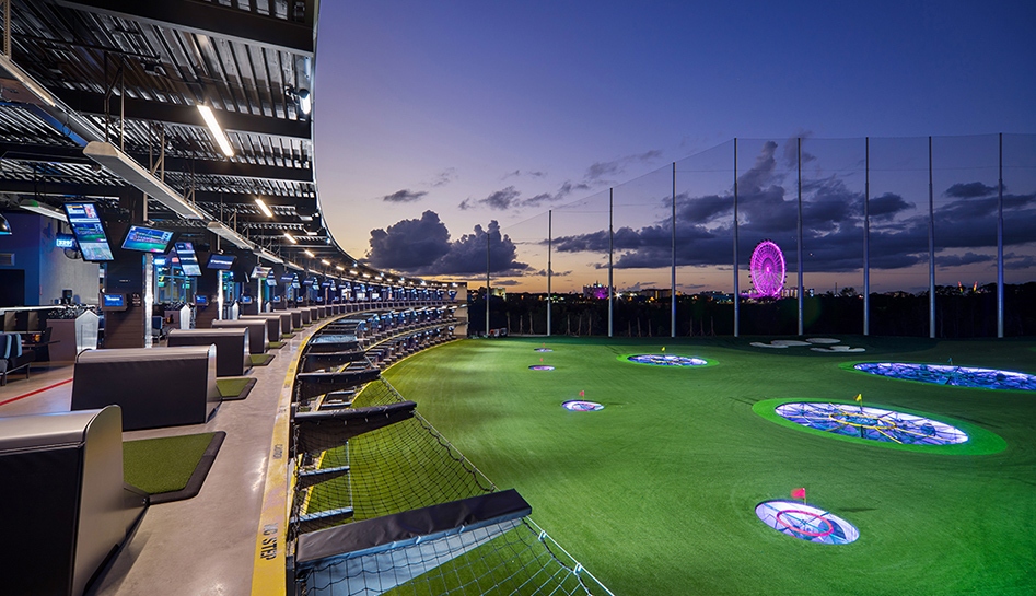 An evening outdoor photo of the green and building at TopGolf. Orlando, Florida.