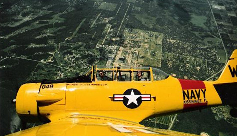 Daytime photo captured from plane wing of yellow airplane flying in the air. Kissimmee, Florida.