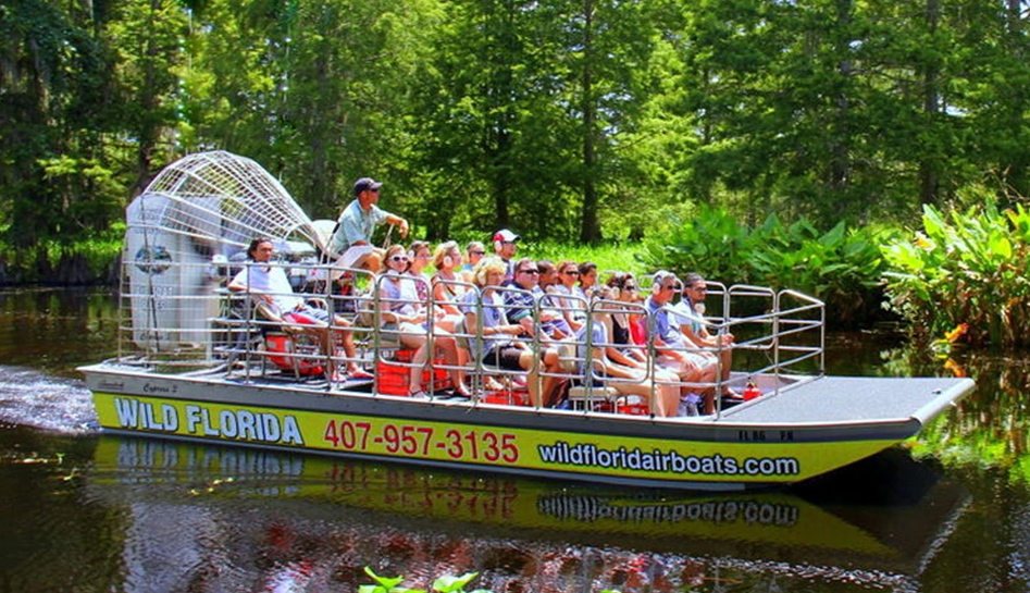 Large group of people in an airboat with 