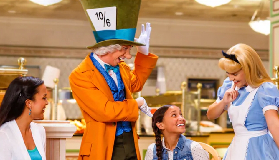 Woman (left) and daughter (middle right) look up at The Mad Hatter (middle left) and Alice (right) from Alice in Wonderland at 1900 Park Fare restaurant. Walt Disney World® Resort. Lake Buena Vista, Florida.