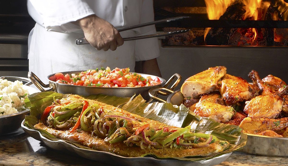 Buffet options from Boma, Flavors of Africa at Walt Disney World® Resort. Chef's hand in background holding tongs. Lake Buena Vista, Florida.